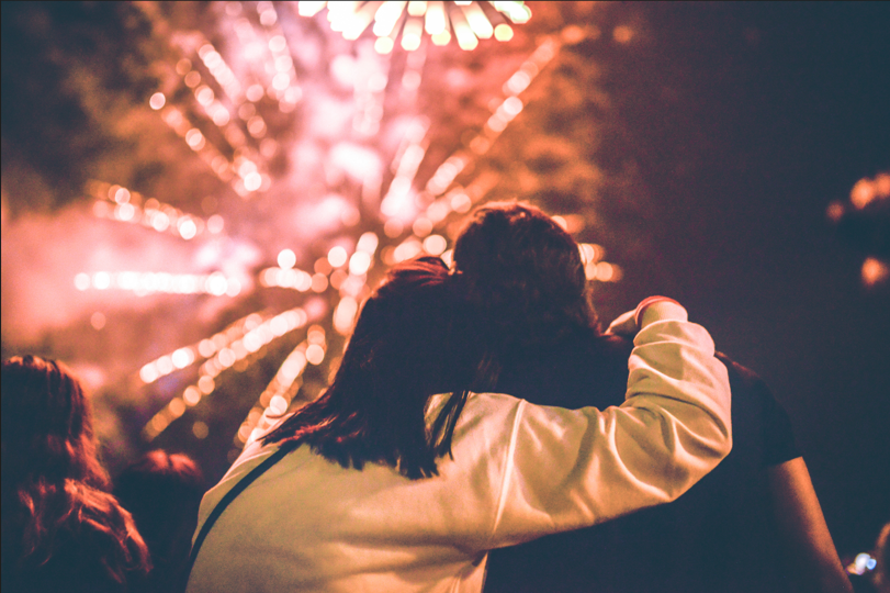 man and woman looking at fireworks